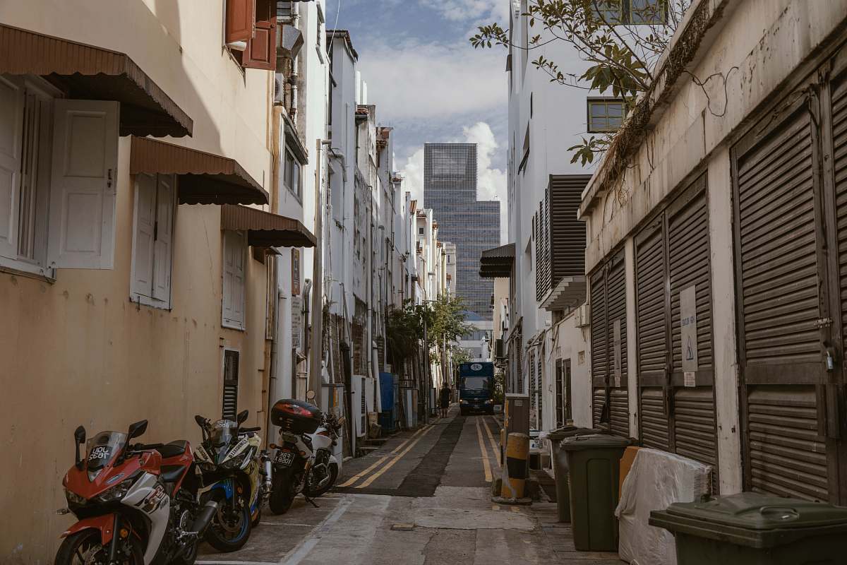city motorcycles parked at the alley beside building road