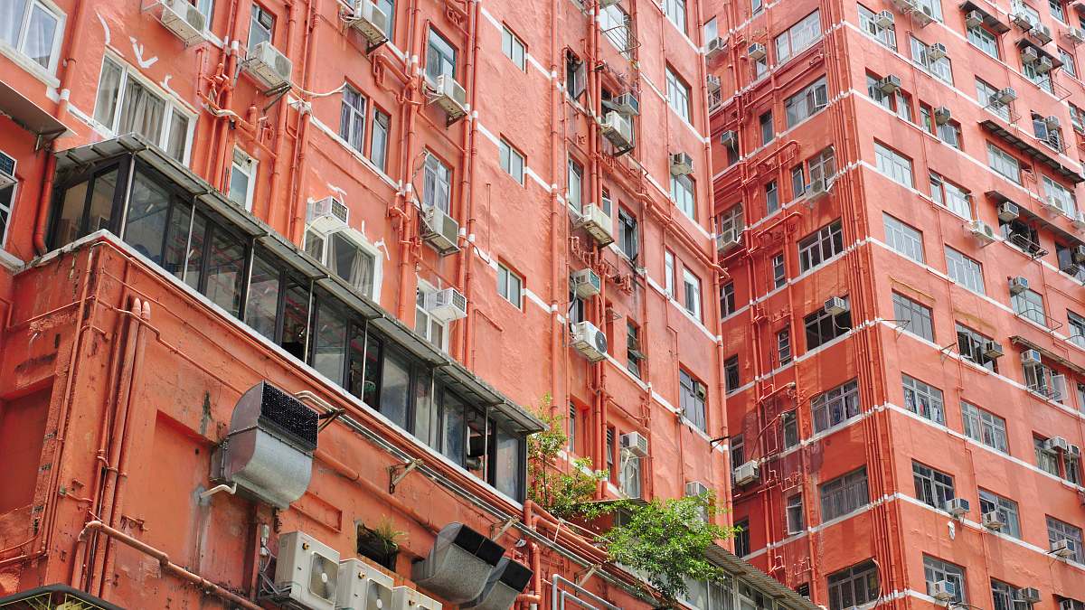 city orange walled building during daytime high rise