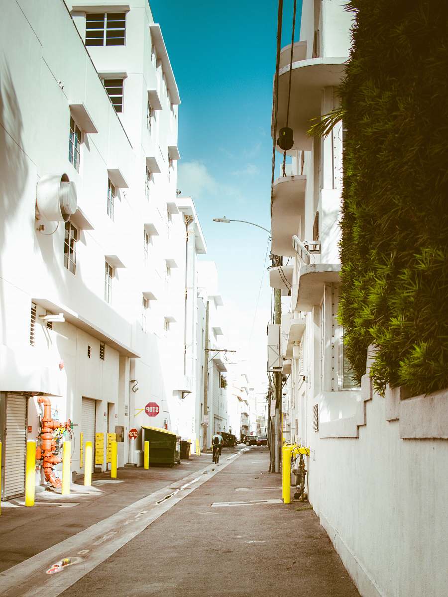 path pathway between white concrete building walkway
