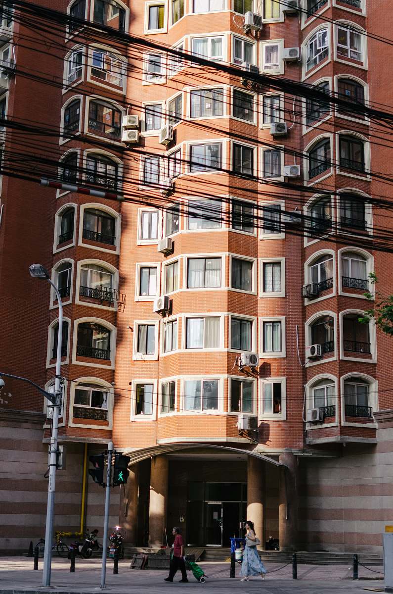 town people in front of brown building during daytime urban