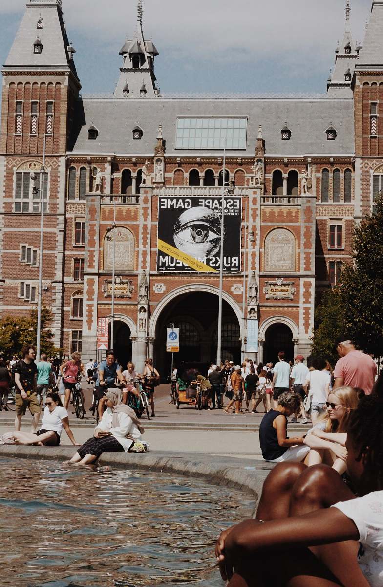 city people in front of brown concrete building downtown