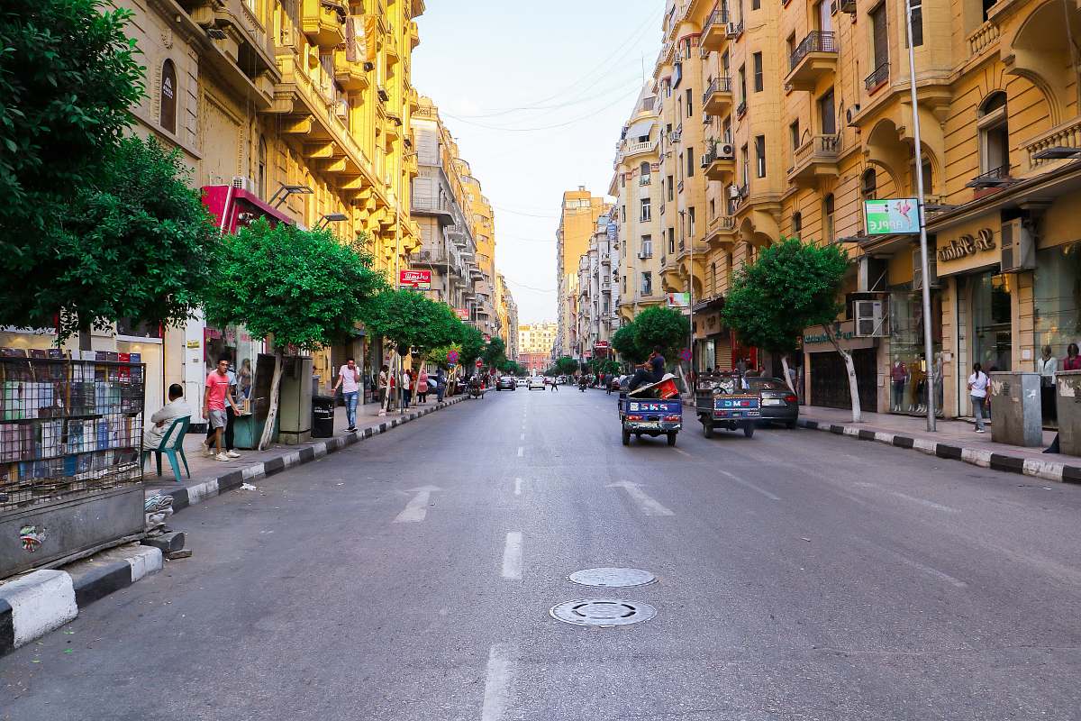 city people in street during daytime road