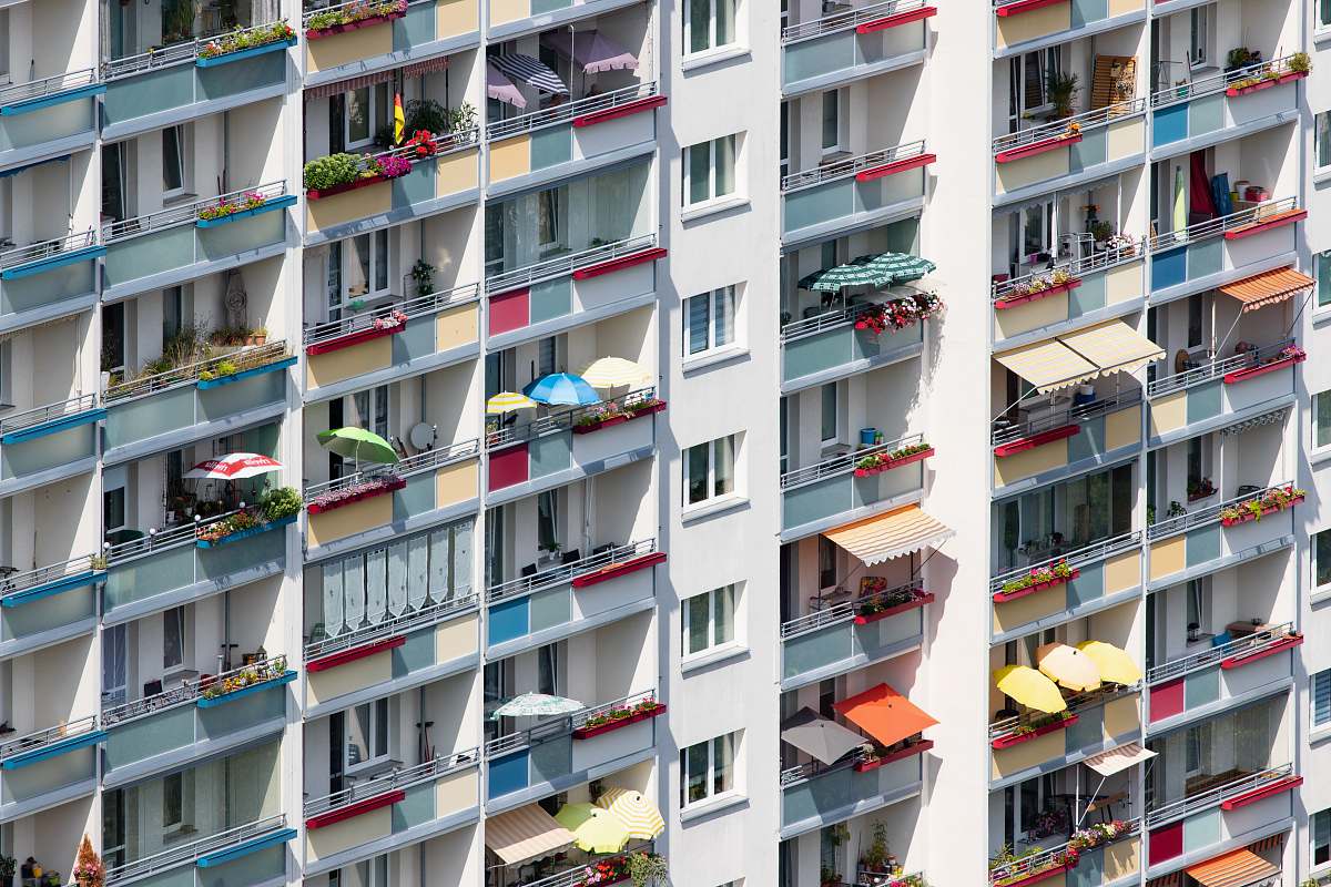 city people in white and multicolored high-rise building high rise