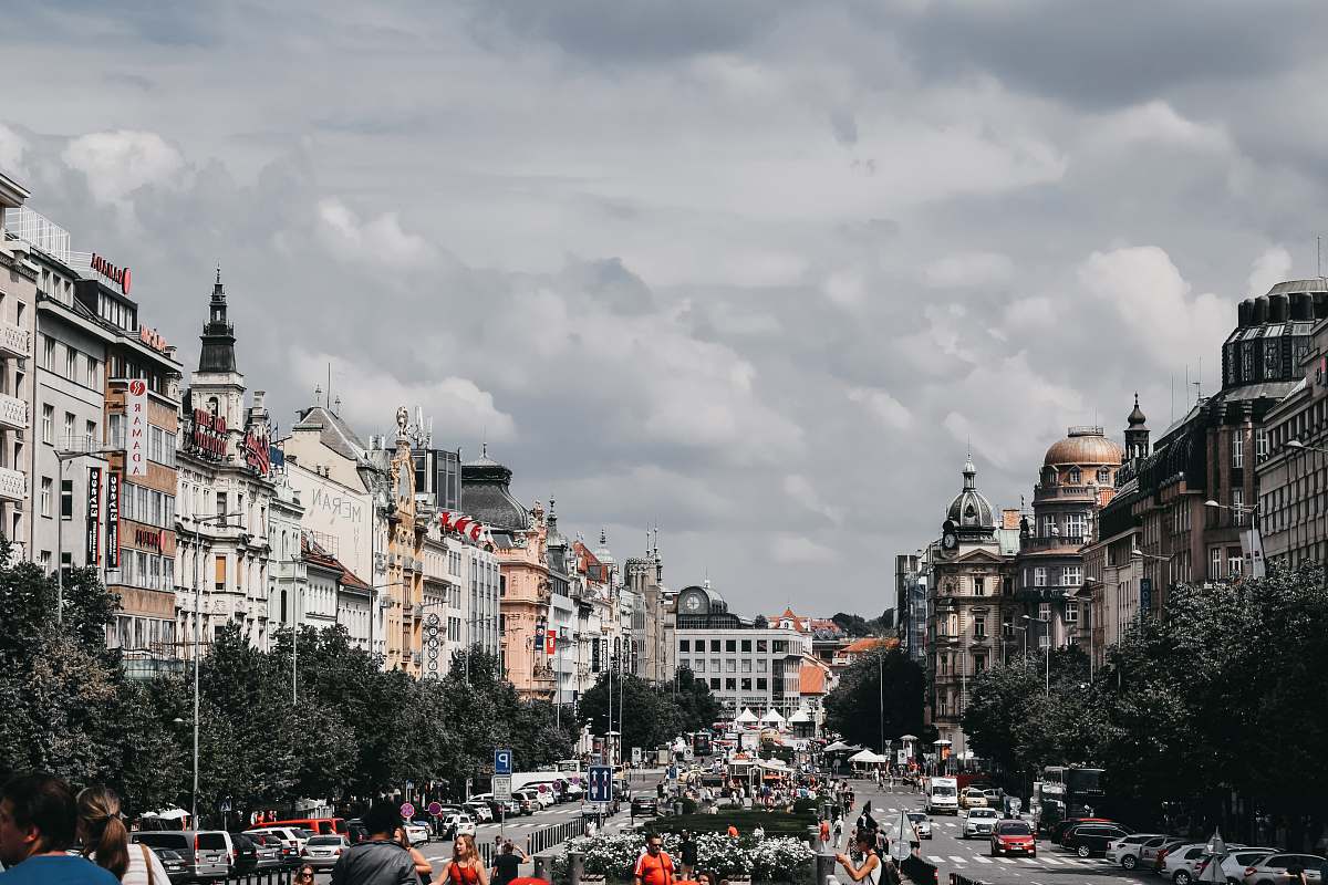 city people near road viewing city with high-rise buildings during daytime person