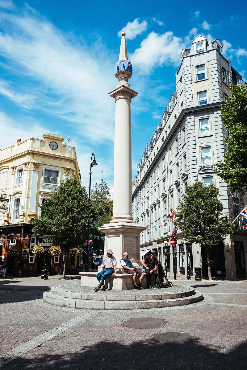 city people sits on concrete tower downtown