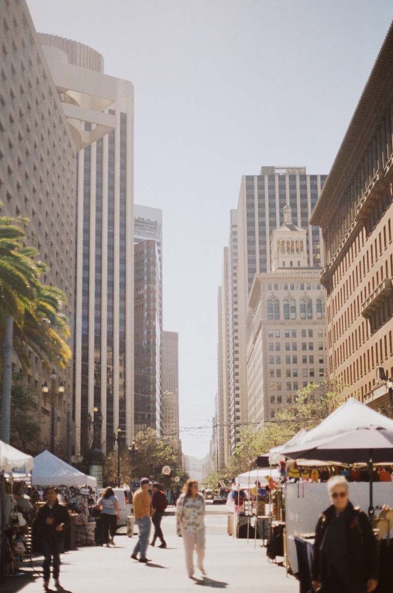 city people waking in between high rise buildings metropolis