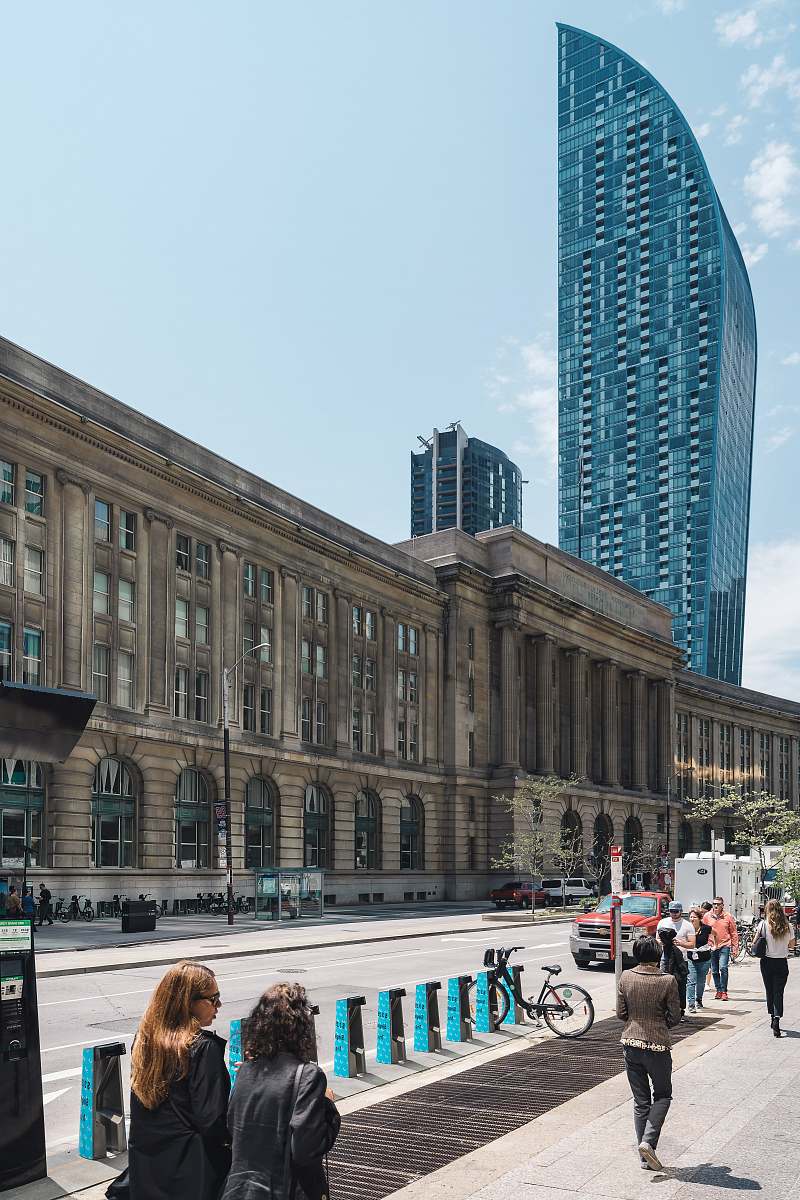 human people walking at the side of brown concrete buildinngg person