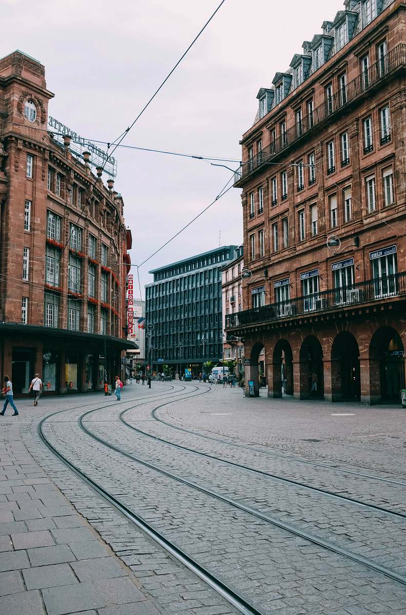 downtown people walking beside building during daytime city