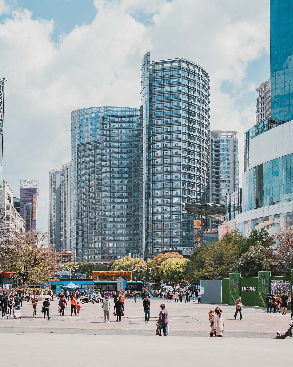 city people walking near buildings during daytime downtown
