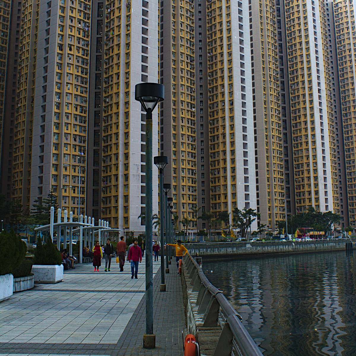 city people walking near high-rise building during daytime high rise