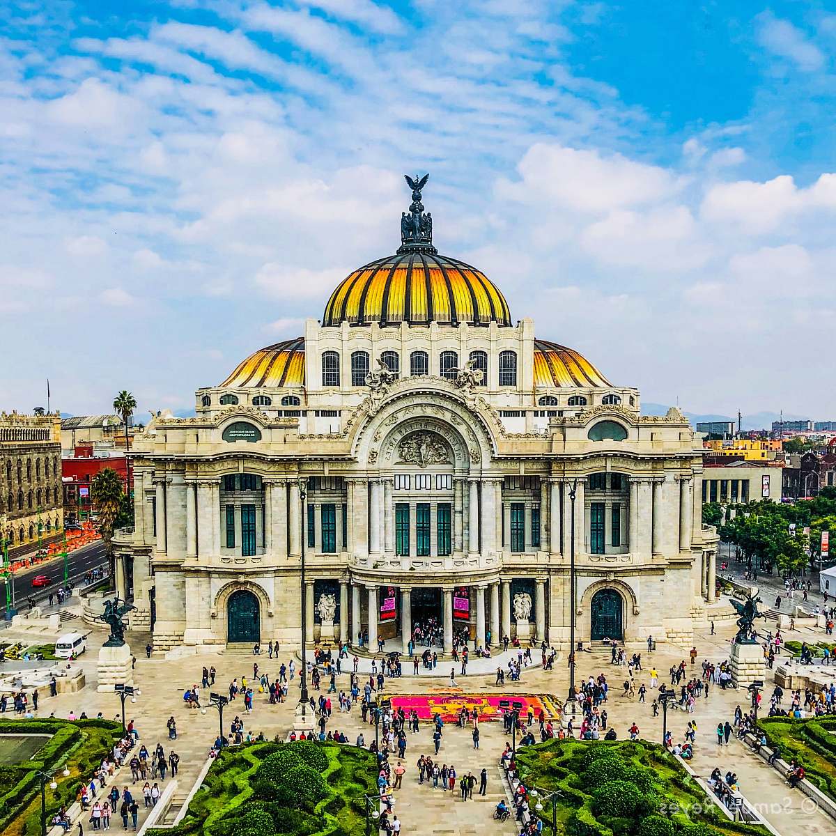 city people walking near Palacio de Bellas Artes in Mexico City under white and blue sky during daytime downtown