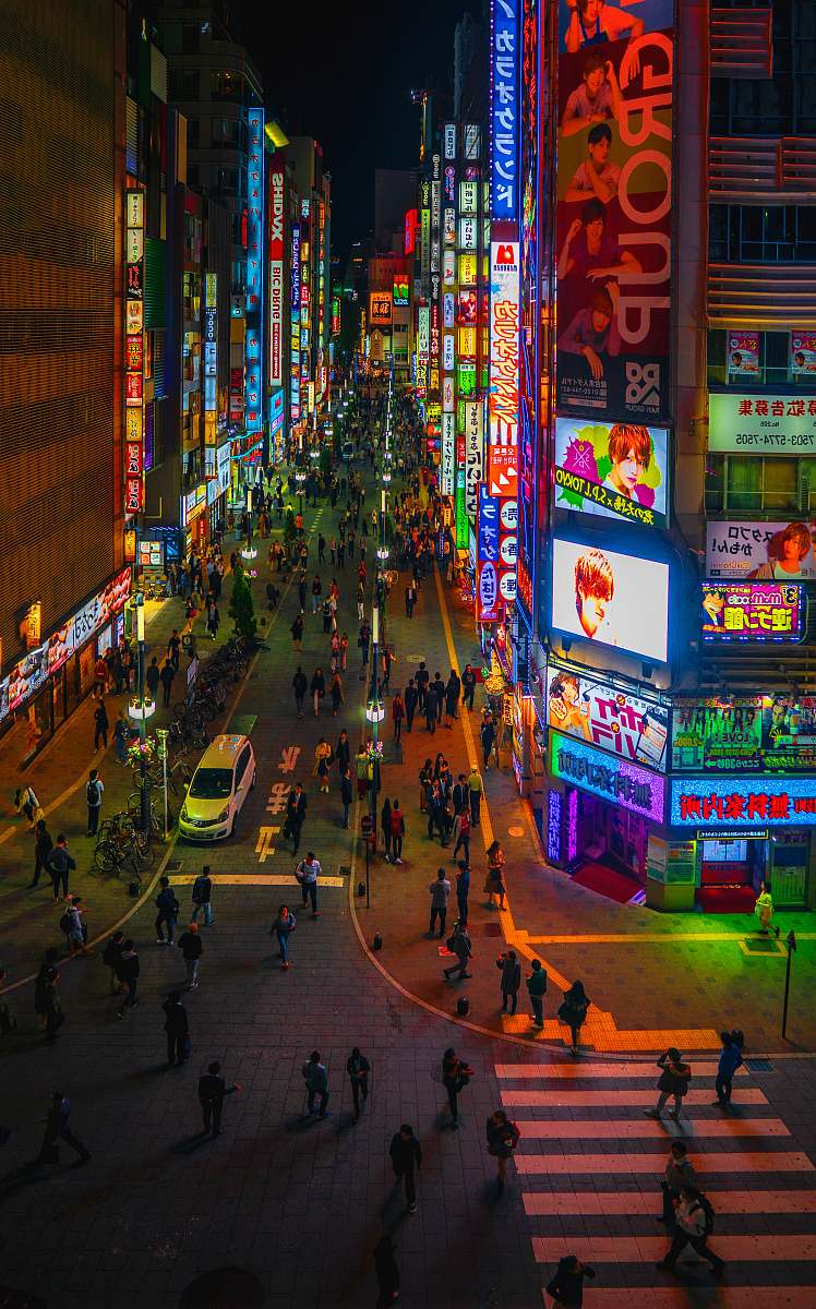 city people walking on road at night downtown