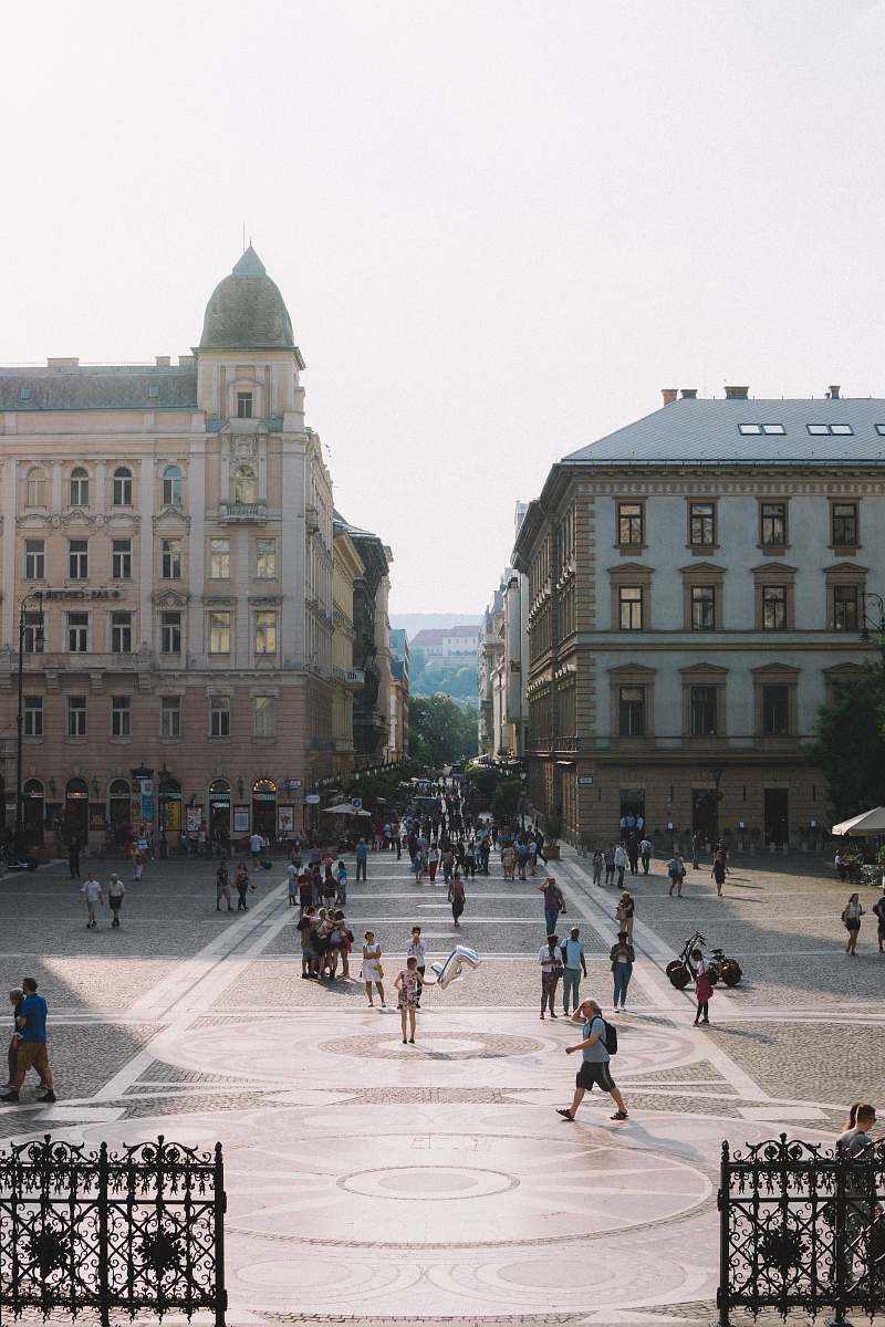 city people walking on street surrounding of building urban