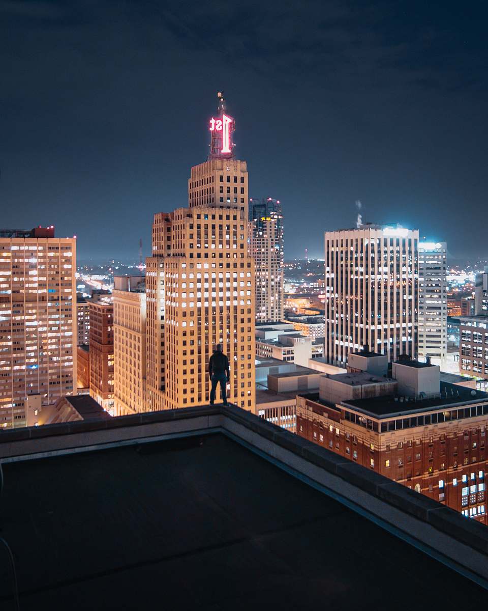 city person standing on the edge of the building urban