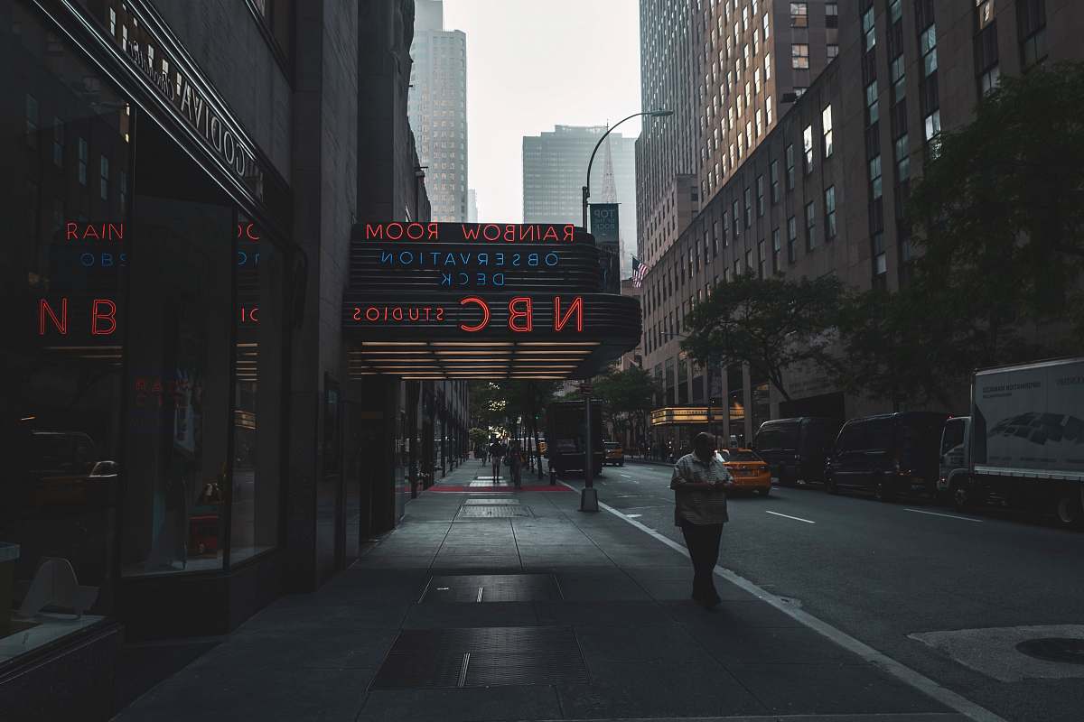 city person walking on sidewalk road