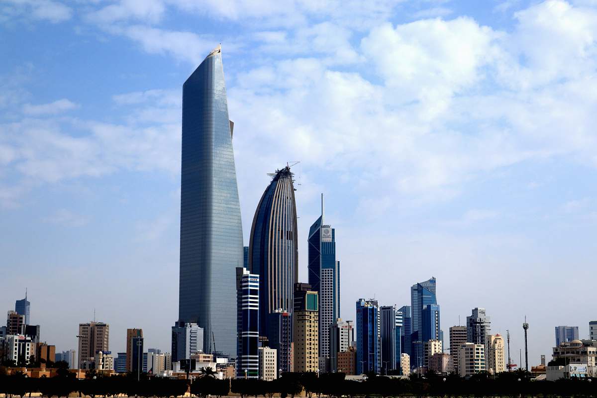 city photography of buildings under blue sky high rise