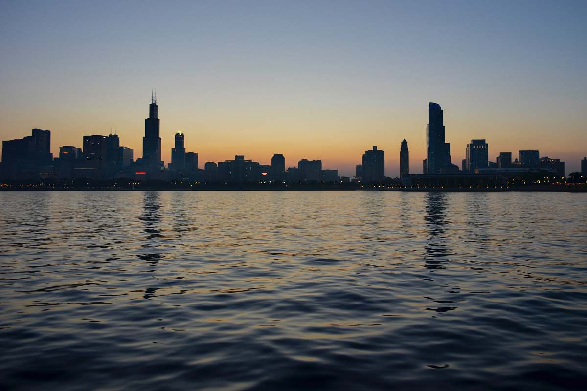 city silhouette of city skyline near body of water skyline