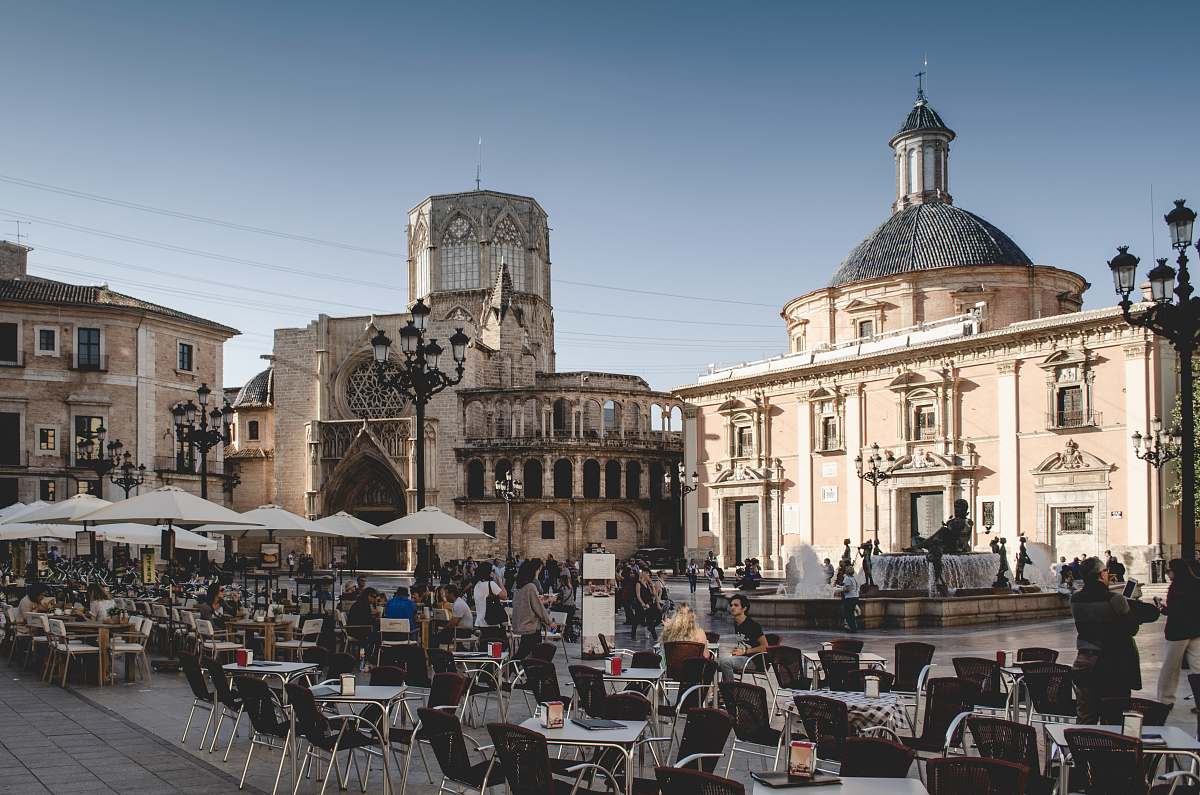 city tables and chairs near building during daytime downtown