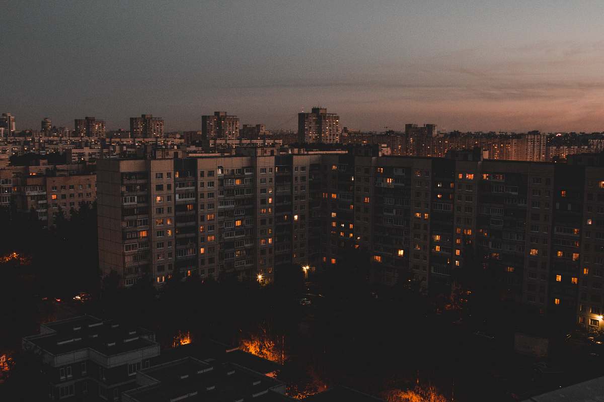 city tall buildings during golden hour with lights high rise