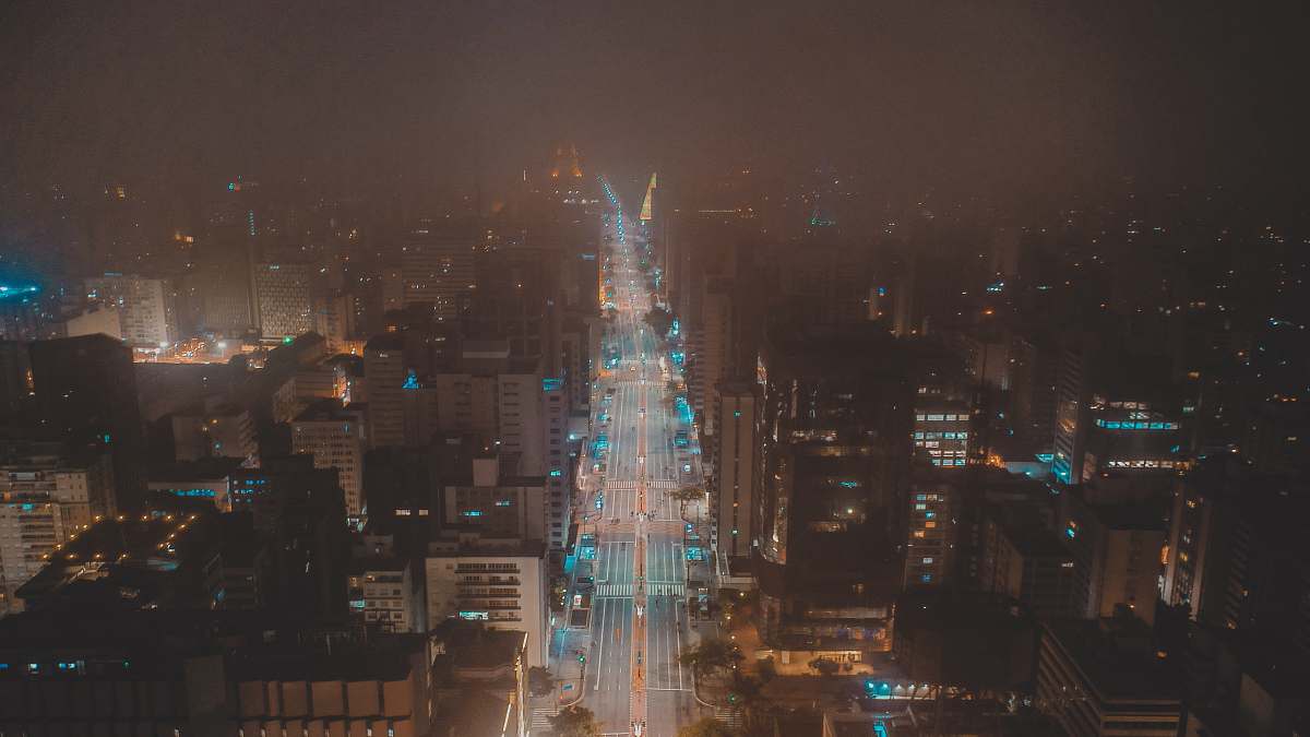 city time lapse photography of road viewing buildings at night time metropolis