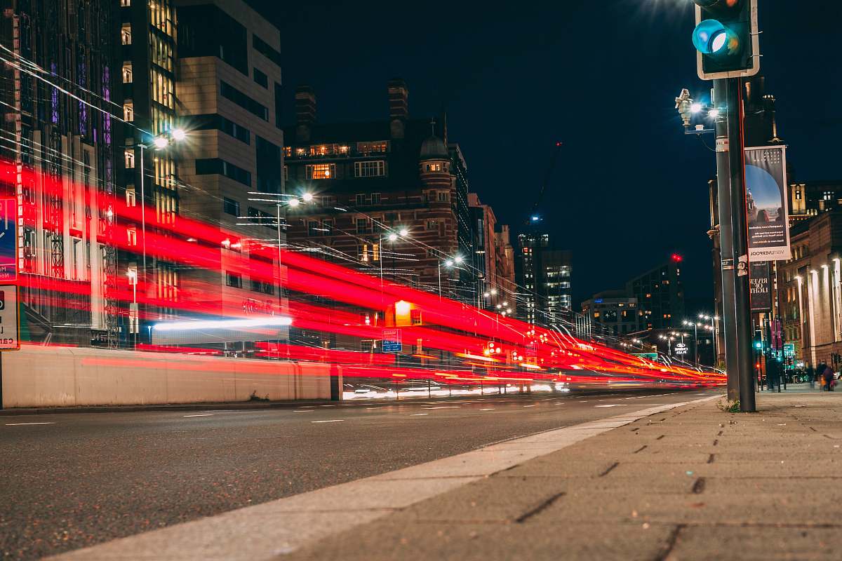 city time-lapse photography of road viewing buildings during night time downtown