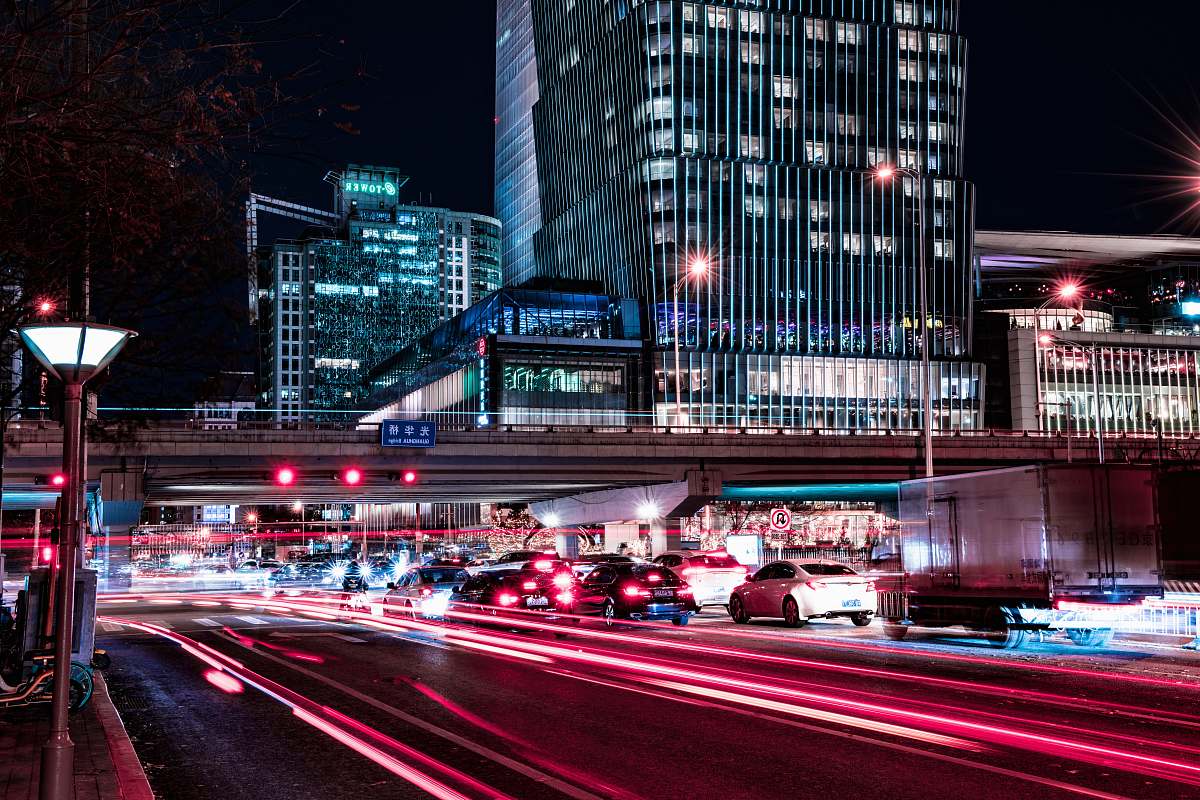 town time lapse photography of vehicles passing by city streets during nighttime metropolis
