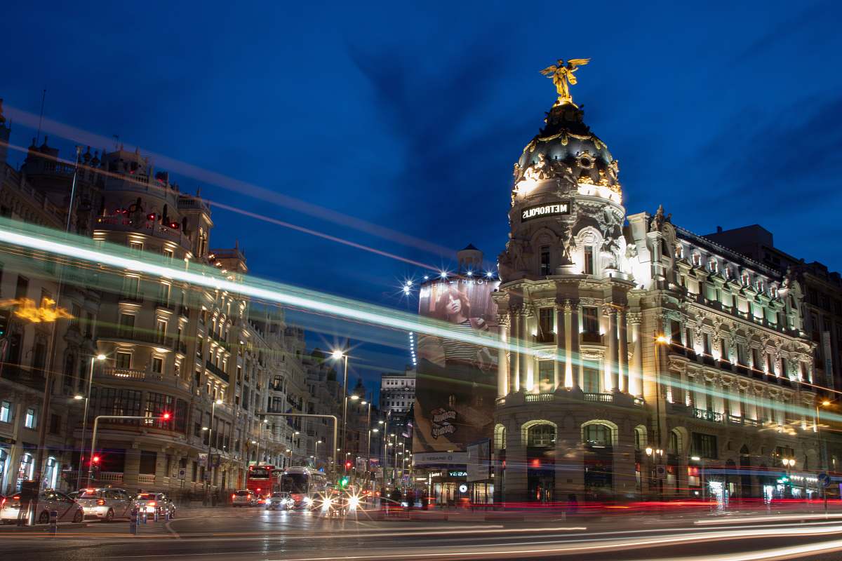 city time lapse photography of vehicles passing on road at night-time downtown