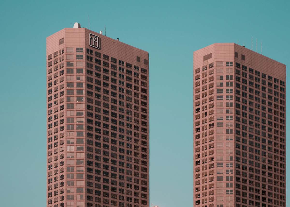 condo two brown towers during daytime housing