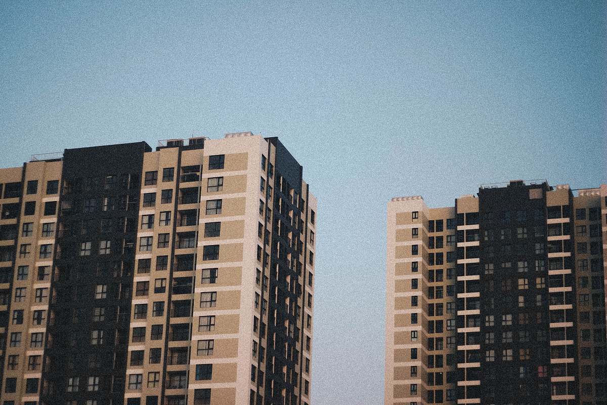 city two gray-and-black concrete high-rise buildings high rise