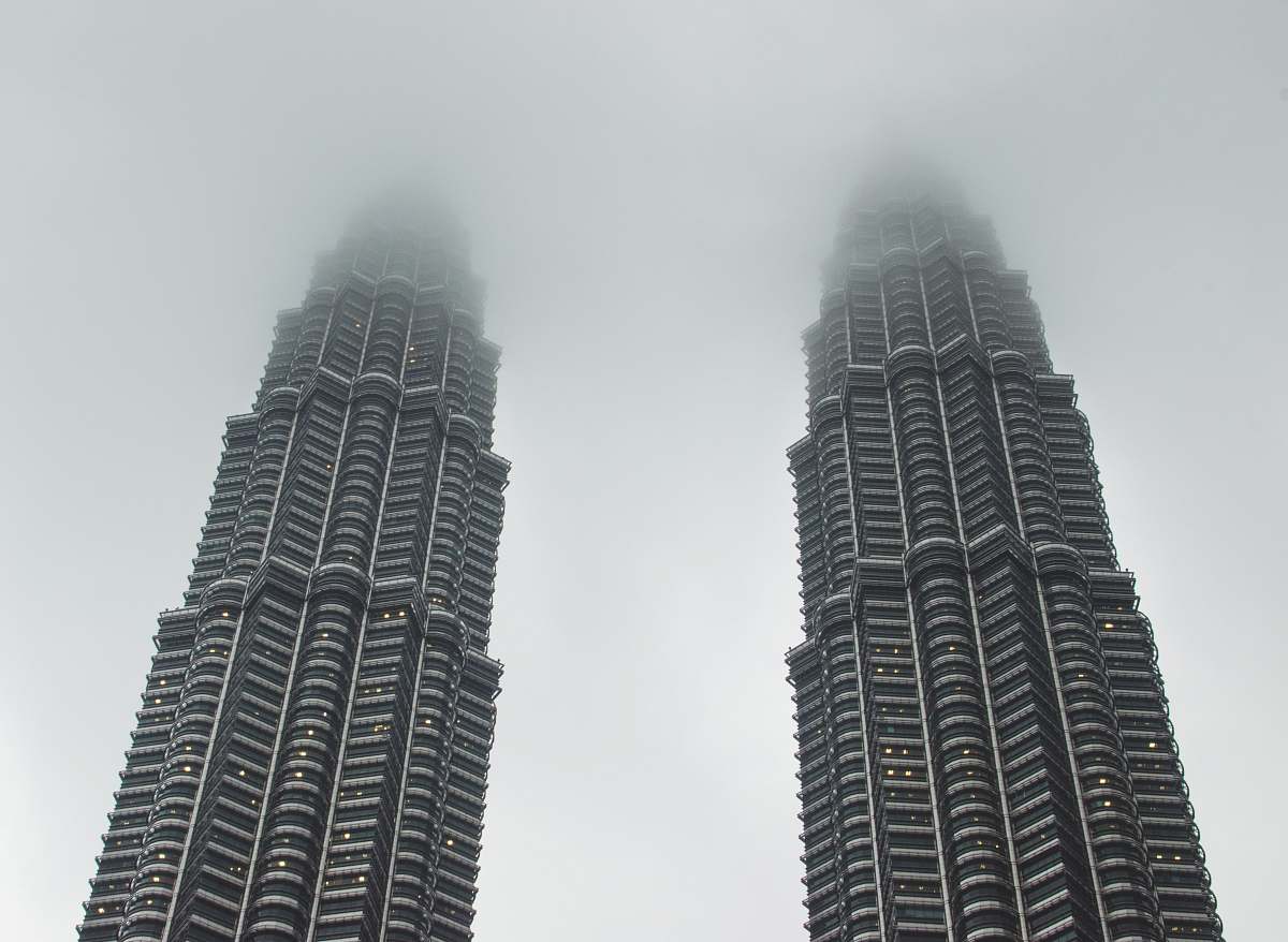 city two gray concrete buildings under white sky high rise