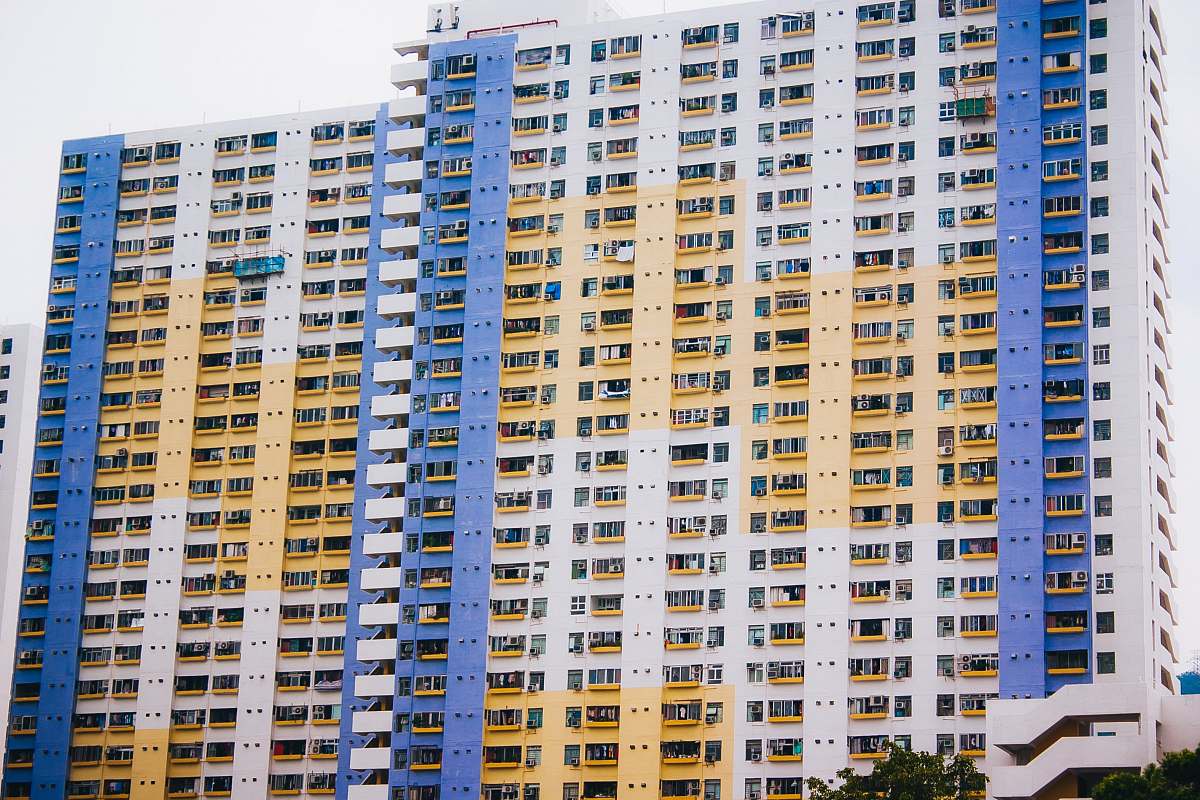 city two white-and-yellow concrete buildings high rise