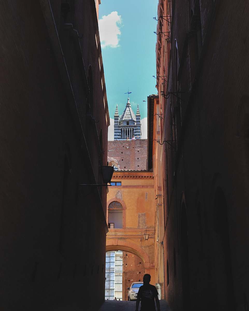 city unknown persons walking on alleyway road