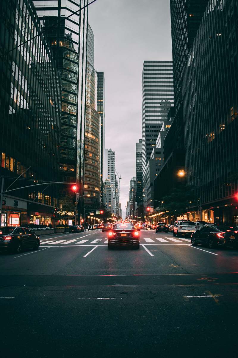 city vehicle on road with taillights on road