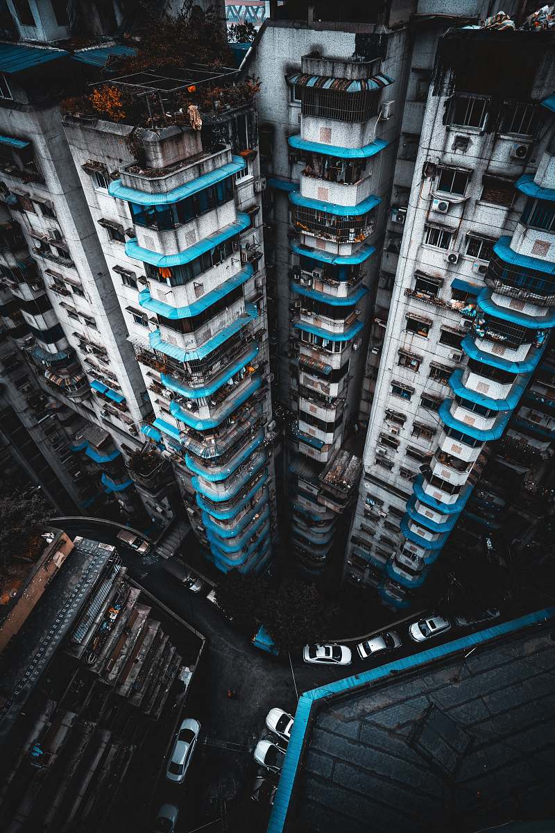 city vehicles near buildings in high-angle photo high rise