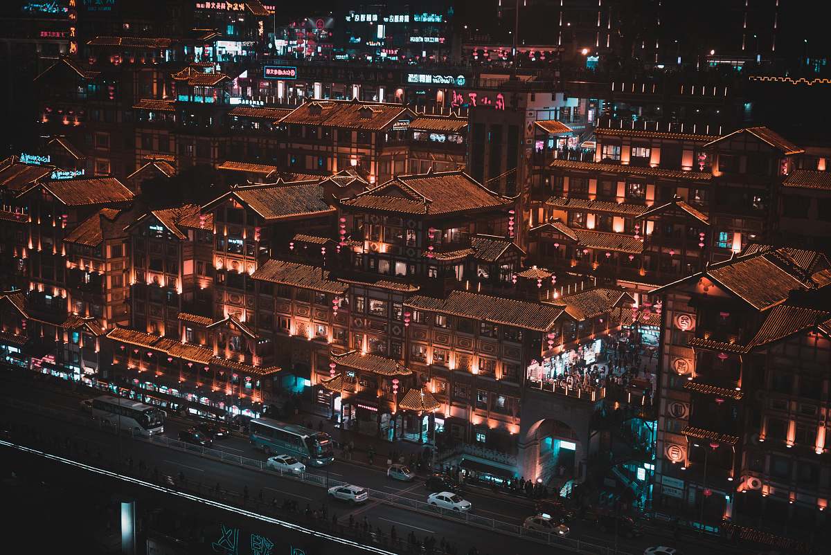 city vehicles on road near buildings at night urban