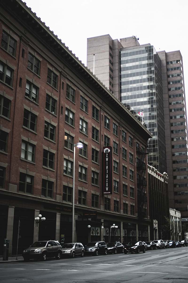 city vehicles park beside brown concrete building urban