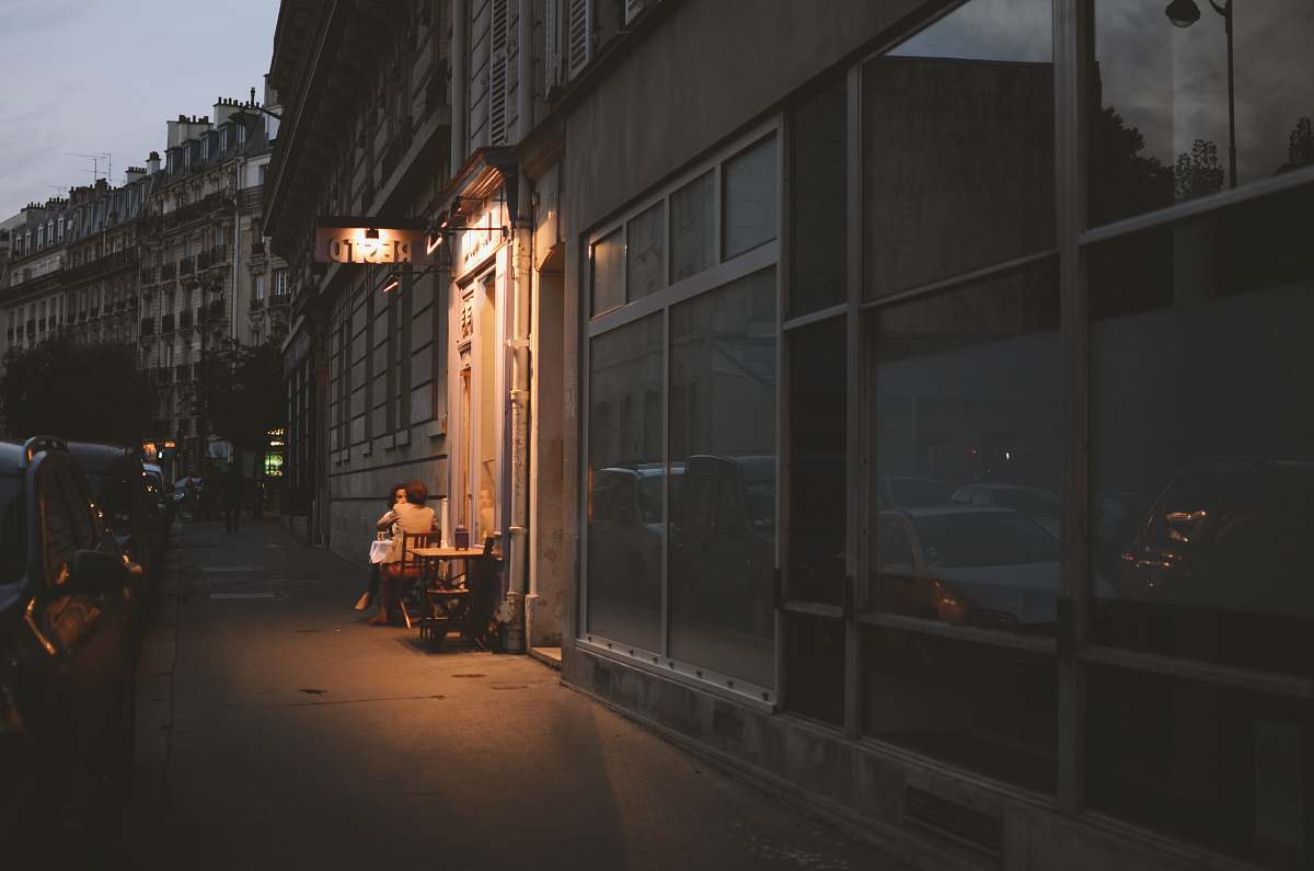 city vehicles parked beside buildings at nighttime road