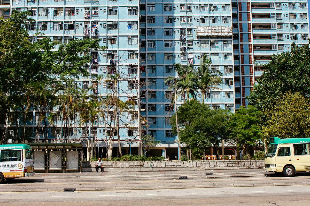 city white and blue van on road near high-rise building town