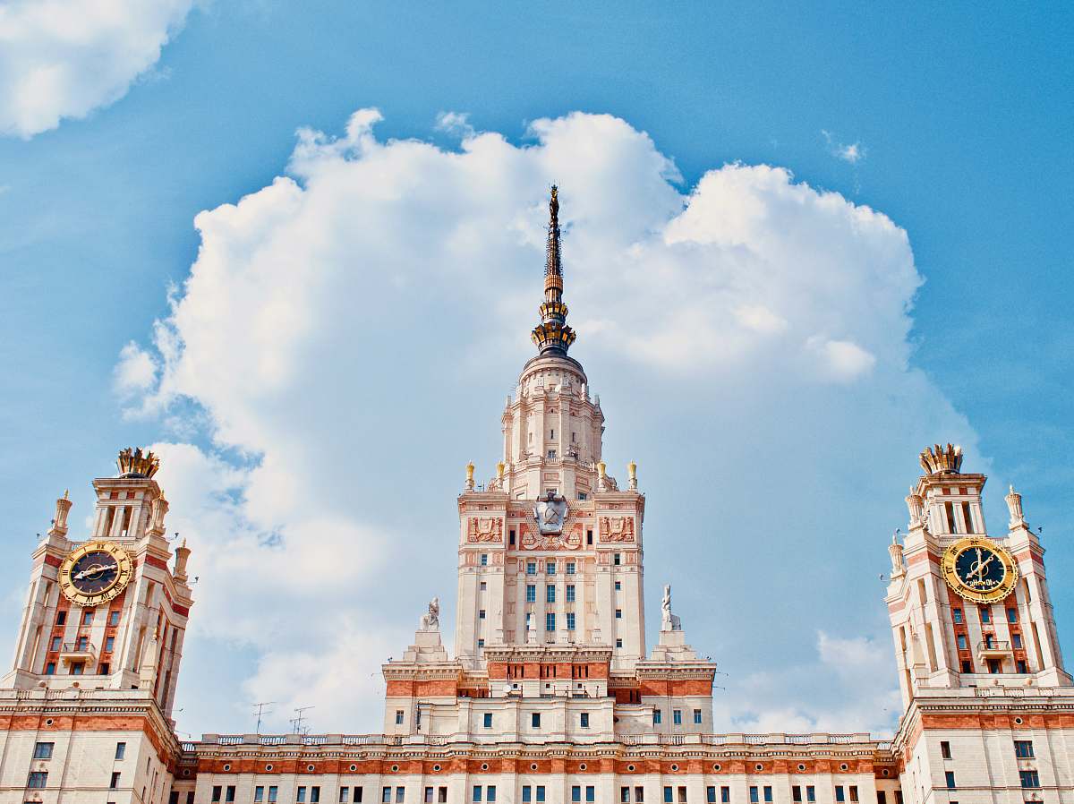 town white and brown concrete building under white clouds during daytime tower