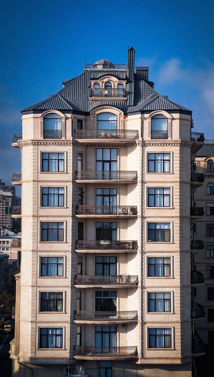 city white and gray concrete building with balconies during day town