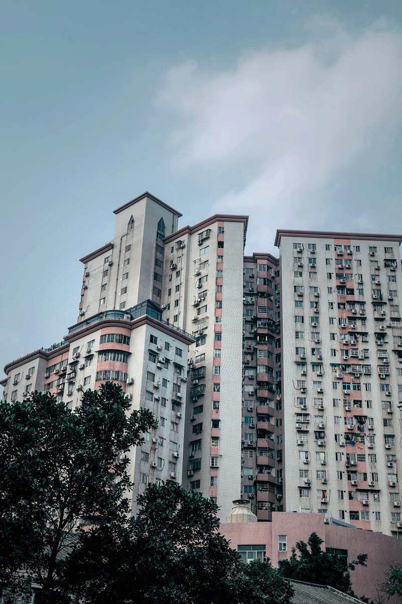city white concrete building under clear blue sky high rise