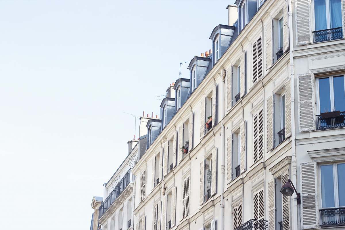 city white concrete building under white sky home decor