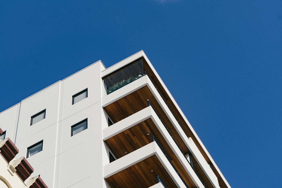 condo white concrete building with balconies during day housing