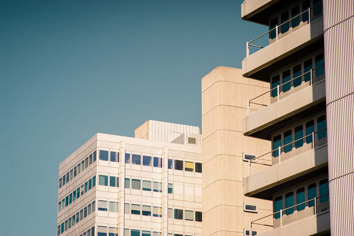 city white concrete high-rise building during daytime high rise