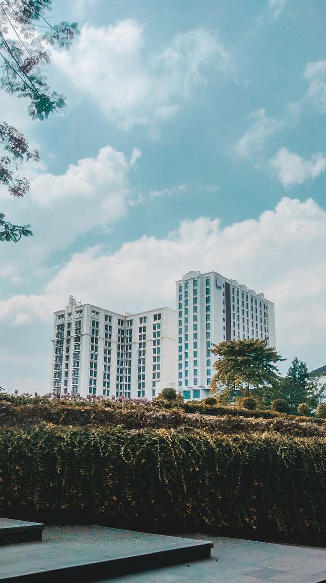 city white high-rise buildings under white and blue skies high rise