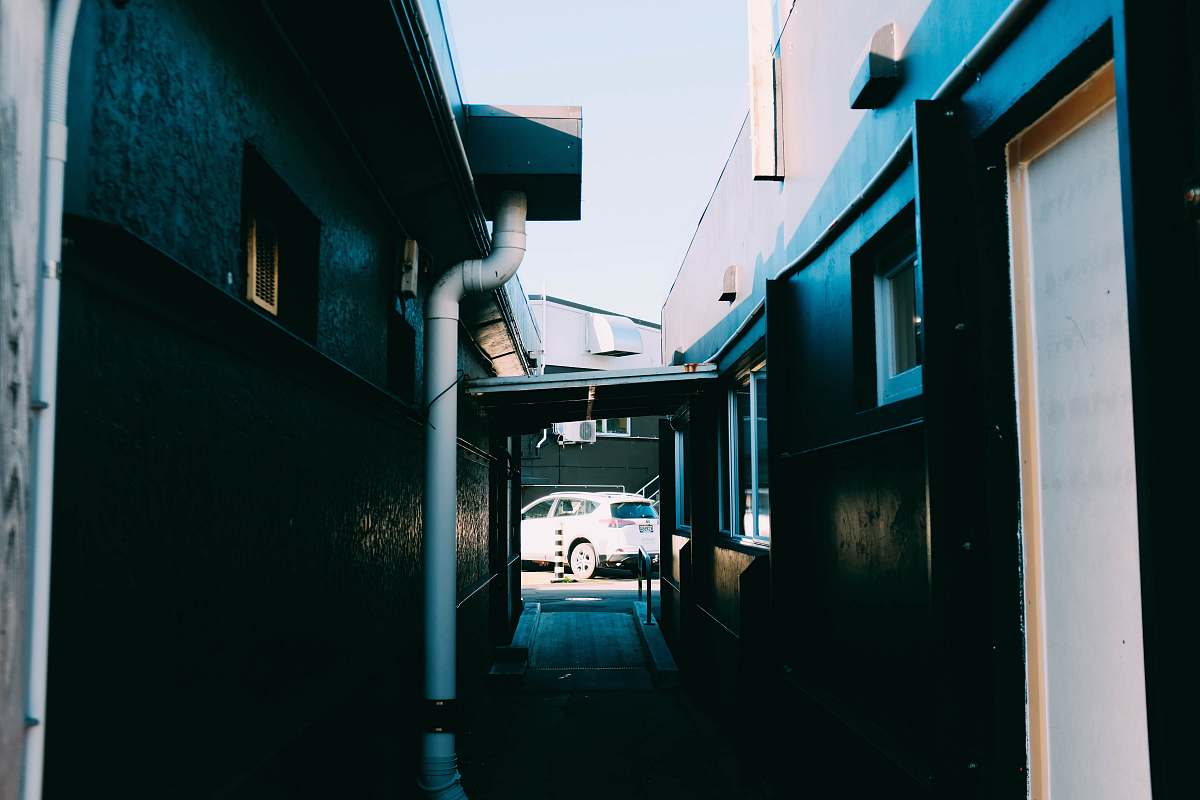 city white vehicle on the end of hallway during daytime road