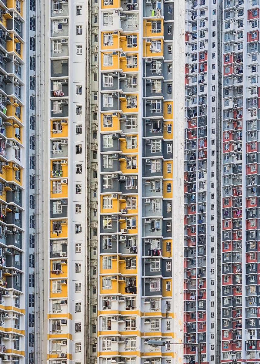 urban white, yellow, and red building high rise