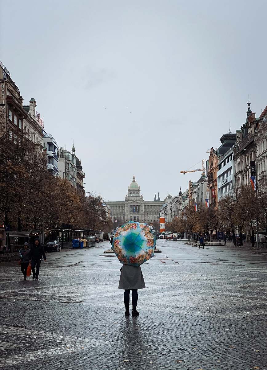 city woman holding an umbrella downtown