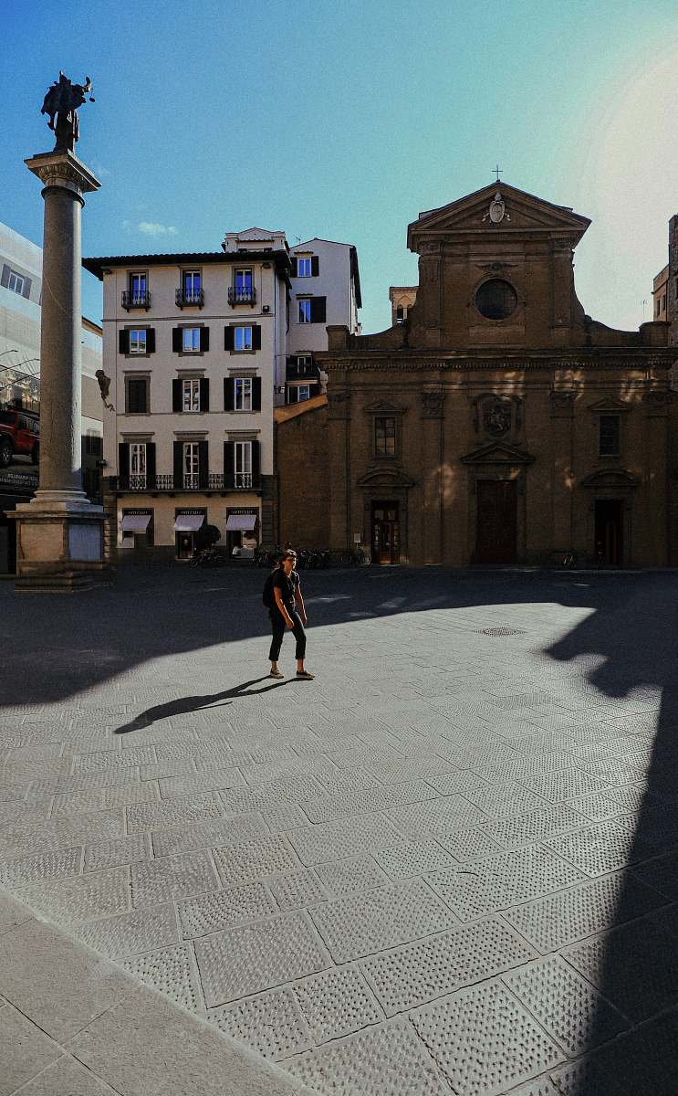 city woman standing on open space downtown