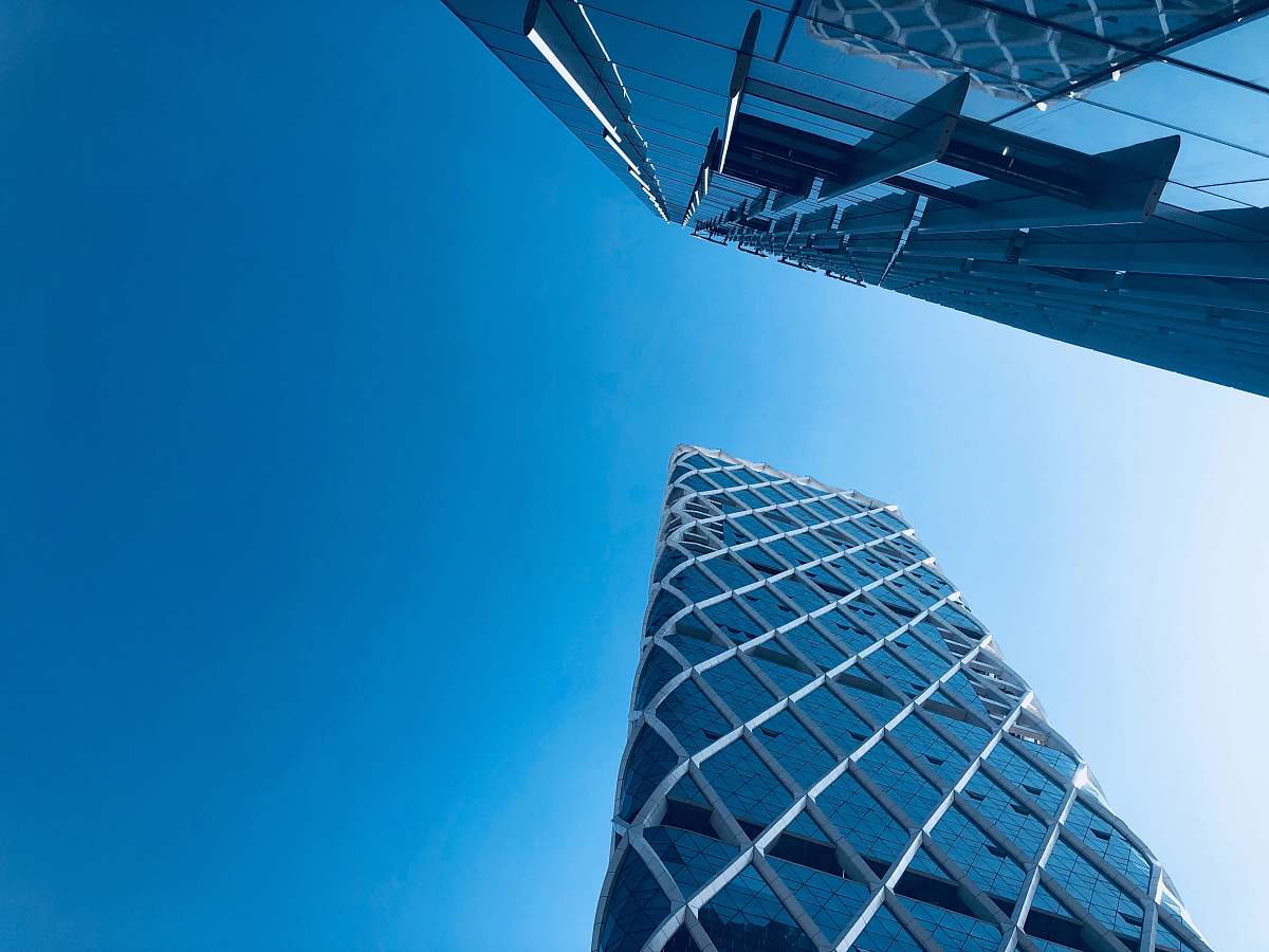 city worm's eye view of two white and gray buildings high rise
